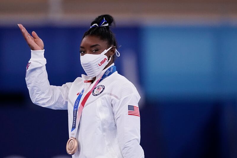 Simone Biles, of the United States, reacts after winning the bronze medal.