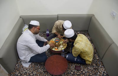 A group of men enjoying mandi, a traditional Yemeni meat-and-rice dish, at a restaurant at Barkas in Hyderabad, India. Taniya Dutta / The National