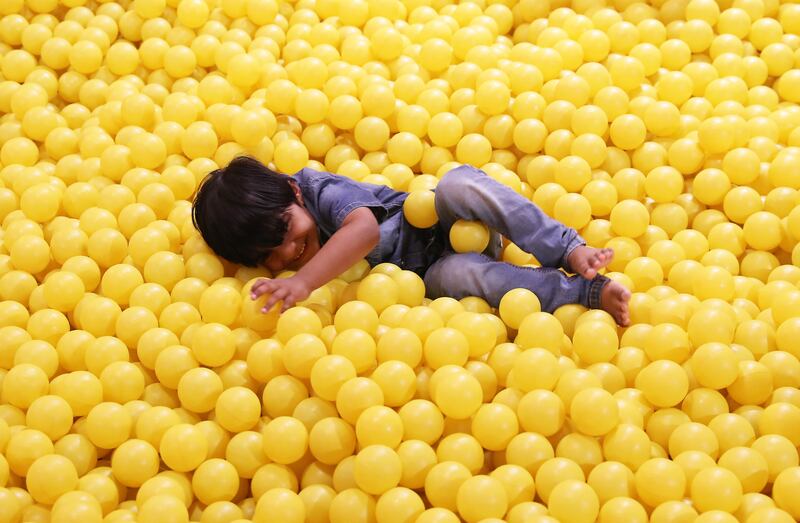 Visitors inside the yellow ball pit area at the Germany Pavilion at the EXPO 2020 site in Dubai. Pawan Singh / The National  