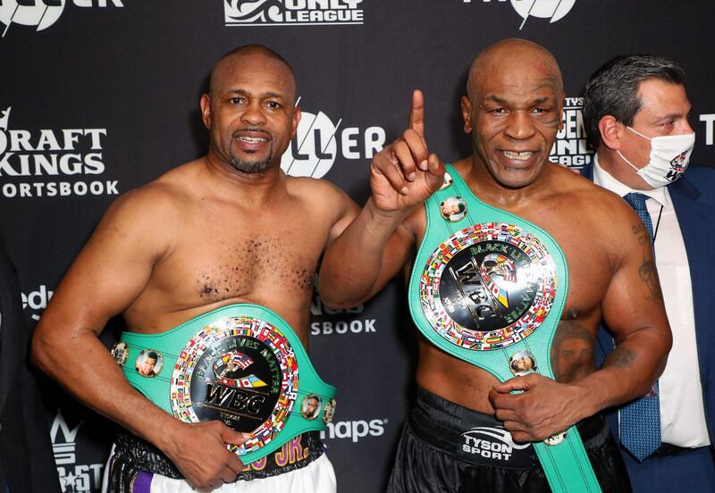This handout images courtesy of Getty Images for Triller shows Roy Jones Jr. (L) and Mike Tyson celebrate their split draw during Mike Tyson vs Roy Jones Jr. presented by Triller at Staples Center on November 28, 2020 in Los Angeles, California.  RESTRICTED TO EDITORIAL USE - MANDATORY CREDIT "AFP PHOTO / Joe SCARNICI / Getty Images for Triller " - NO MARKETING - NO ADVERTISING CAMPAIGNS - DISTRIBUTED AS A SERVICE TO CLIENTS
 / AFP / Getty Images North America / Joe Scarnici / RESTRICTED TO EDITORIAL USE - MANDATORY CREDIT "AFP PHOTO / Joe SCARNICI / Getty Images for Triller " - NO MARKETING - NO ADVERTISING CAMPAIGNS - DISTRIBUTED AS A SERVICE TO CLIENTS
