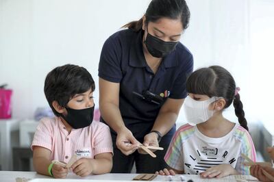 Dubai, United Arab Emirates - Reporter: N/A. Photo project. Children's summer activities. Nomdar and Fatma do mechanical engineering with instructor Sunshine at the OliOli summer camp. Summer activities for teenagers and children open up after school has finished with Covid-19/Coronavirus protection measures. Tuesday, July 14th, 2020. Dubai. Chris Whiteoak / The National