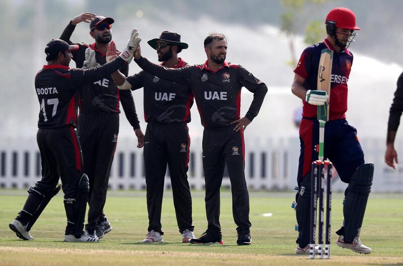 ABU DHABI , UNITED ARAB EMIRATES , October 22  – 2019 :- Rohan Mustafa of UAE ( center ) celebrating after taking the wicket of Ben Stevens ( right ) during the World Cup T20 Qualifiers between UAE vs Jersey held at Tolerance Oval cricket ground in Abu Dhabi.  ( Pawan Singh / The National )  For Sports. Story by Paul