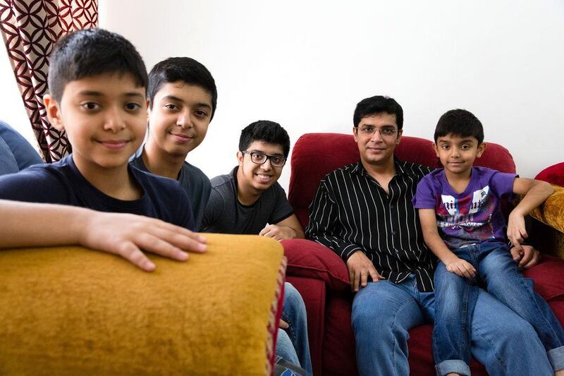 Zubair Ahmed author of the book 'Power to Kids' with his family at home in Abu Hail, Dubai. (Left to Right) Murtaza, Mujtaba, Mustafa, Zubair and Muqtada Ahmed. Duncan Chard for the National. *** Local Caption ***  DC0817-Power_to_kids-TN130802DC0054.jpg
