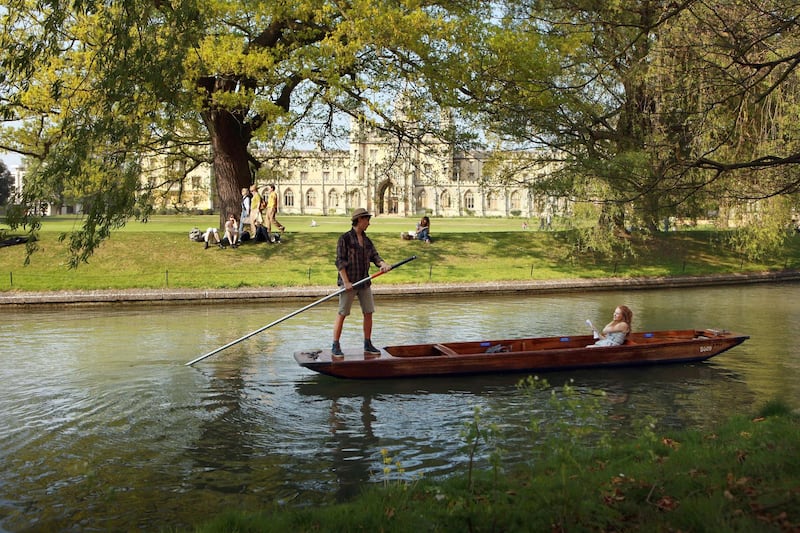 CAMBRIDGE, UNITED KINGDOM - APRIL 19:  Members of the public punt along the river Cam in front of the colleges of Cambridge University on April 19, 2011 in Cambridge, England. The UK is currently basking in fine weather with the Met Office predicting temperatures up to 25C this week. The fine weather comes as many people are taking advantage of the combination of a late Easter and additional Bank Holiday for the Royal Wedding to take extended breaks and holidays.  (Photo by Oli Scarff/Getty Images)