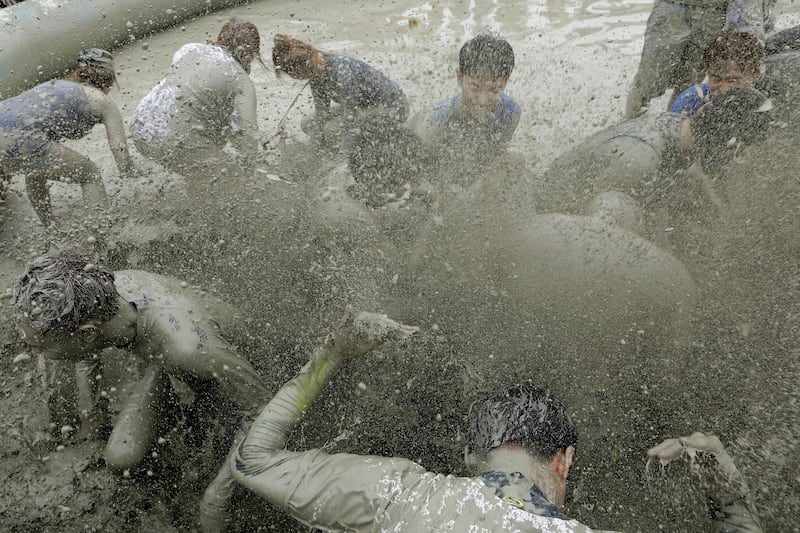 Festival-goers enjoy the mud during the annual Boryeong Mud Festival at in Boryeong, South Korea. The mud, which is believed to be beneficial for the skin due to its mineral content, is sourced from mud flats near Boryeong and transported to the beach by truck.  Chung Sung-Jun.