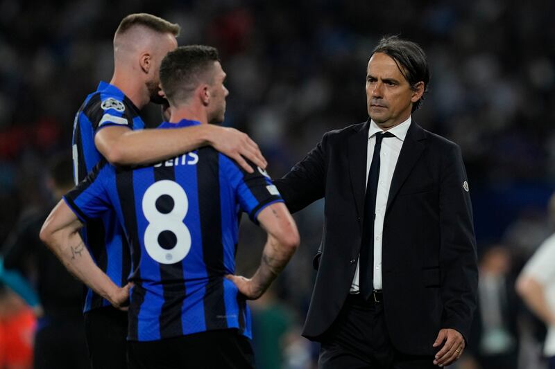 Inter Milan manager Simone Inzaghi, right, comforts his players after defeat in the Champions League final. AP