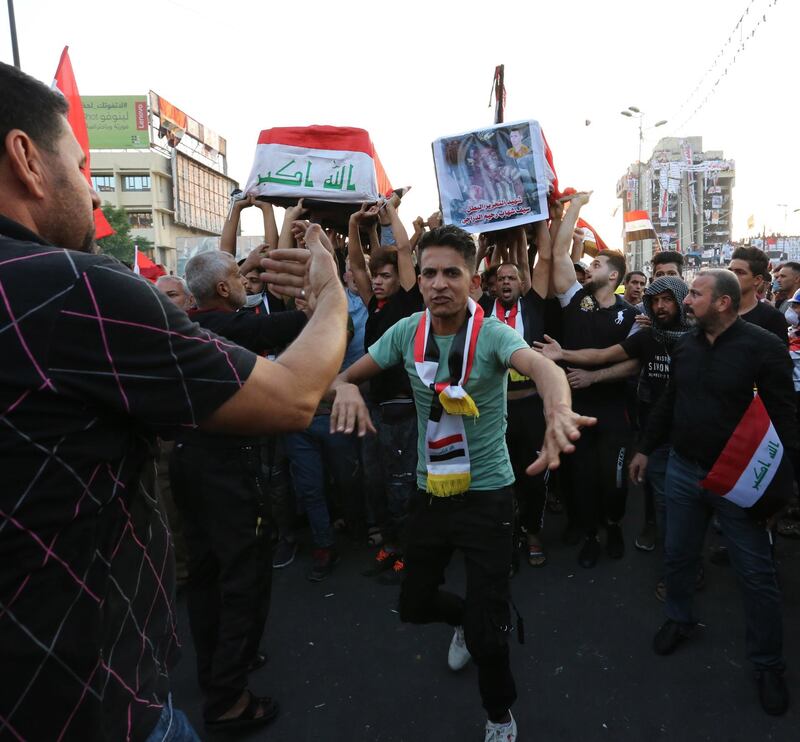 Iraqis carry the coffins of two protesters who were killed by security forces during funeral procession at Tahrir square in central Baghdad, Iraq.  EPA