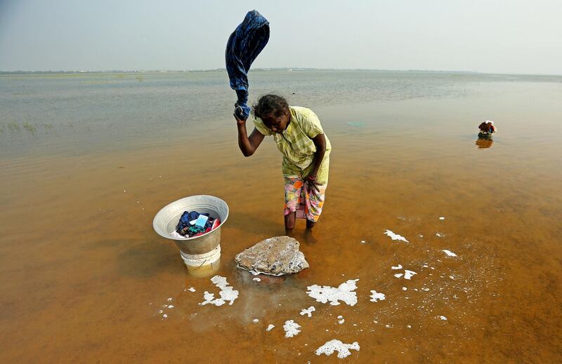 A woman washes clothes in Puzhal lake  in Chennai, India. P Ravikumar / Reuters