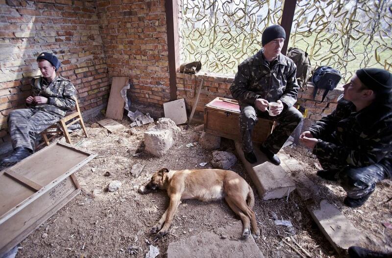 Ukrainian airmen sit at the Belbek air base in Crimea. The base commander Colonel Yuliy Mamchur said he was still waiting orders from the Ukrainian defense ministry. Vadim Ghirda / AP Photo / March 21, 2014