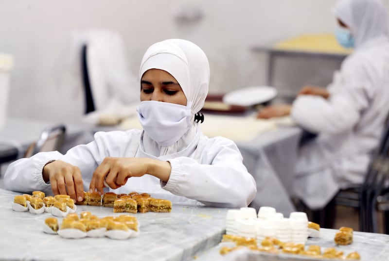 A woman makes pastry at the Masmoudi factory in Sfax, Tunisia. All photos: EPA