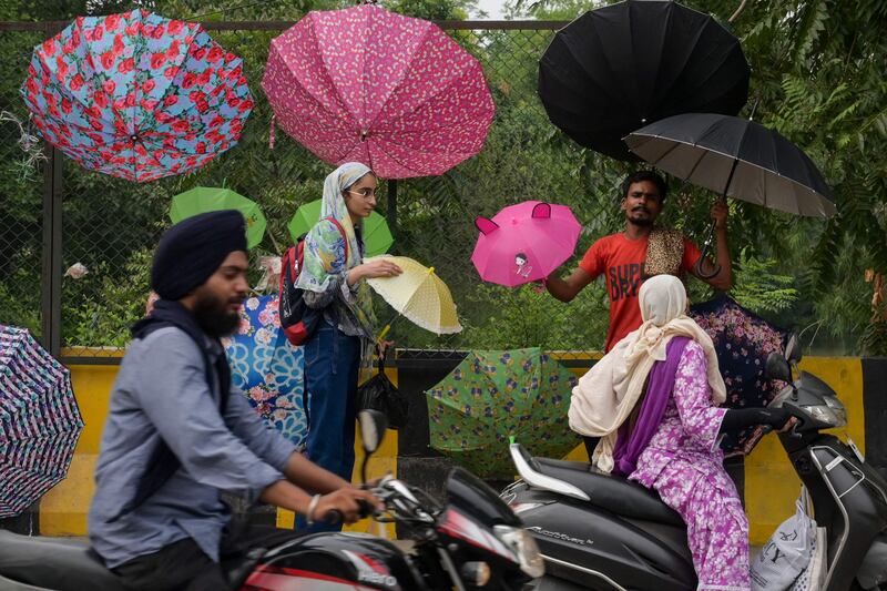 A roadside vendor sells umbrellas to commuters in Amritsar. AFP