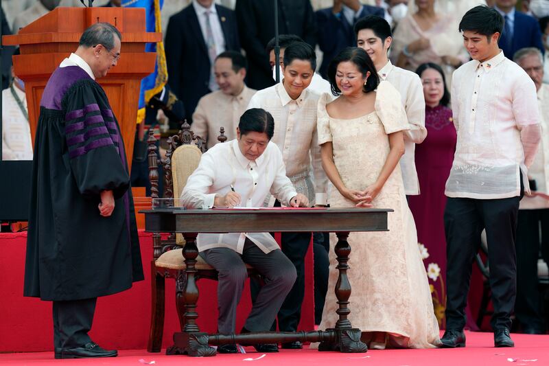 Mr Marcos Jr is sworn in by Supreme Court Chief Justice Alexander Gesmundo. AP