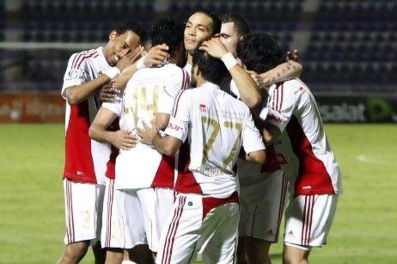 Al Jazira teammates congratulate Ricardo Oliveira, centre. Mike Young / The National