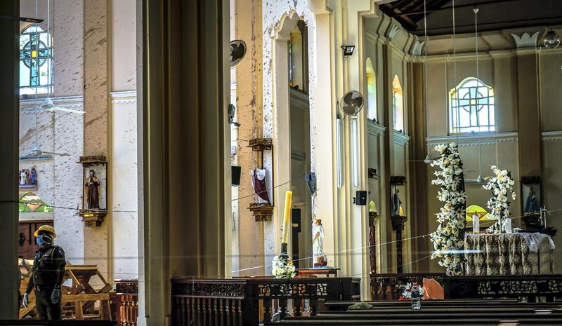 An investigator inspects the damaged interior of St Sebastian’s Church in Negombo, Sri Lanka, April 23, 2019. Jack Moore / The National. 

