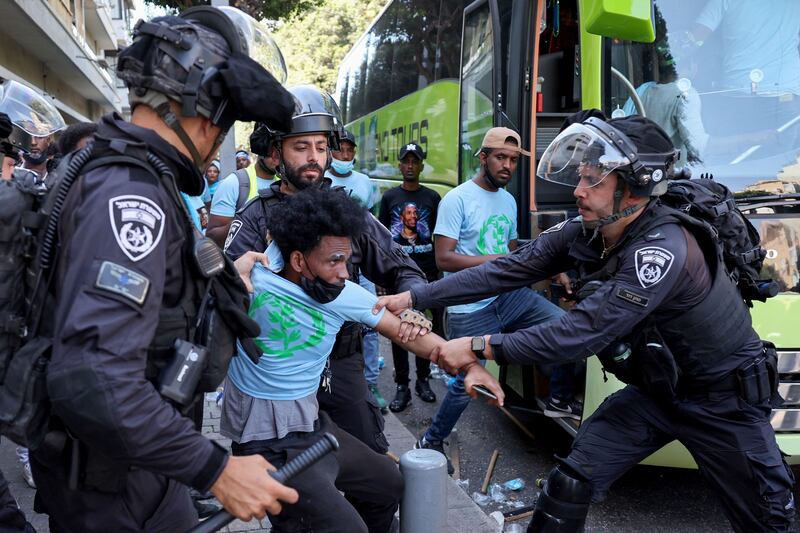 Members of Israel's security forces clash with Eritrean asylum seekers protesting an event organised by Eritrea's government in Tel Aviv. AFP