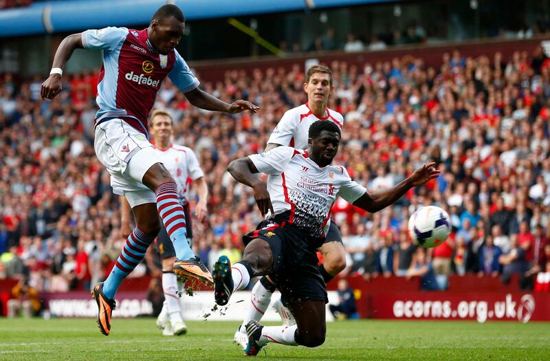 Aston Villa's Christian Benteke (L) shoots past Liverpool's Kolo Toure during their English Premier League soccer match at Villa Park in Birmingham, central England, August 24, 2013.   REUTERS/Darren Staples   (BRITAIN - Tags: SPORT SOCCER) FOR EDITORIAL USE ONLY. NOT FOR SALE FOR MARKETING OR ADVERTISING CAMPAIGNS. NO USE WITH UNAUTHORIZED AUDIO, VIDEO, DATA, FIXTURE LISTS, CLUB/LEAGUE LOGOS OR "LIVE" SERVICES. ONLINE IN-MATCH USE LIMITED TO 45 IMAGES, NO VIDEO EMULATION. NO USE IN BETTING, GAMES OR SINGLE CLUB/LEAGUE/PLAYER PUBLICATIONS *** Local Caption ***  DST08_SOCCER-ENGLAN_0824_11.JPG