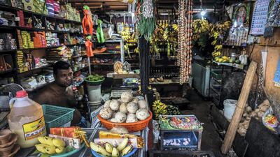 A Tamil shop owner sits behind the counter on Galle Road, Colombo, a stone's throw from the Indian Ocean. Jack Moore/The National