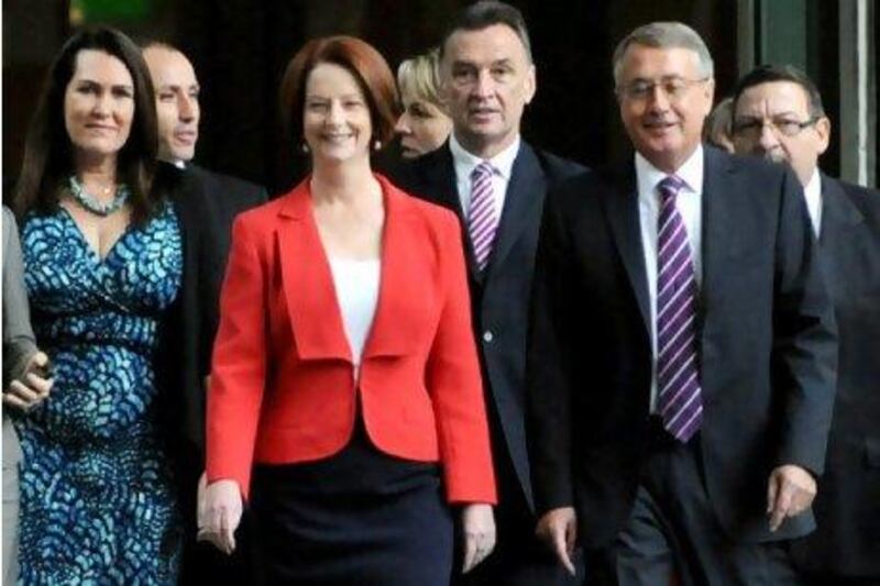 Australian Prime Minister Julia Gillard, centre, arrives with supporters for the caucus meeting in Parliament House in Canberra. Ms Gillard survived a leadership challenge from Kevin Rudd, trouncing the former leader in a damaging battle to head the ruling Labor party.