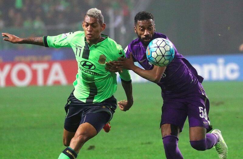 Jeonbuk Hyundai Motors' Ricardo Lopes, left, vies for the ball with Al Ain's Mohammed Fayez during the Asian Champions League final first leg  in Jeonju on November 19, 2016. AFP