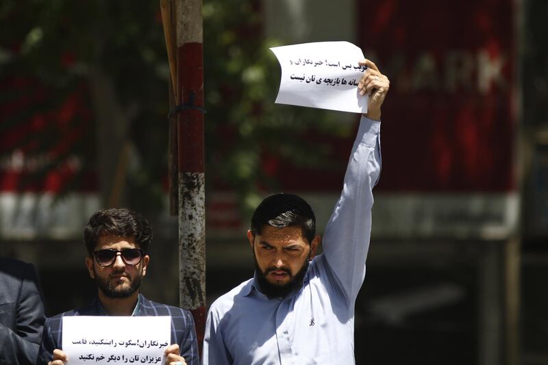 epa06708500 Afghan journalists hold placards reading in Dari 'Stop deceiving - Journalists are not something to play with' during a protest boycotting an ongoing official conference marking International Day of Media in Kabul, Afghanistan 03 May 2018. Reporters blame Afghan journalists safety committee and Afghan government for not providing enough facilities and security for media in the backdrop of the bomb blast this week that killed at least nine Afghan journalists.  EPA/JAWAD JALALI