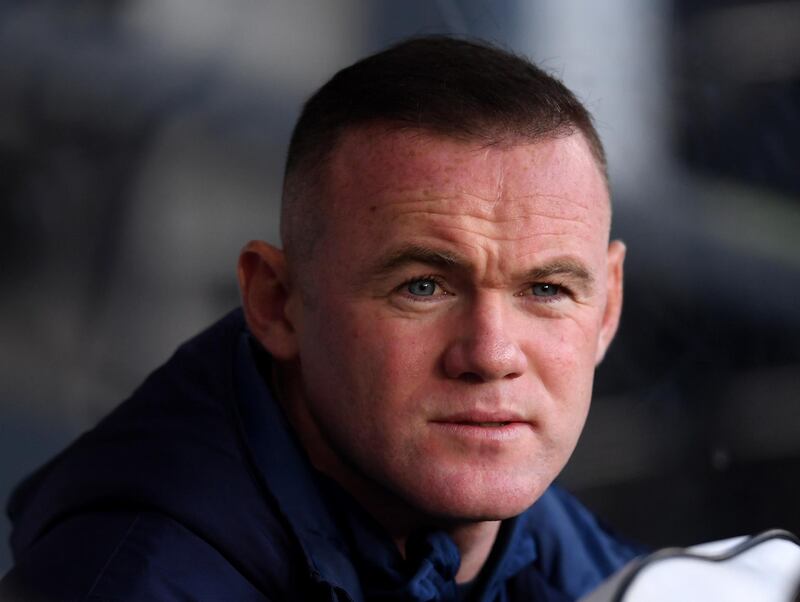 Wayne Rooney watches the Derby v QPR match from the dugout. Getty Images