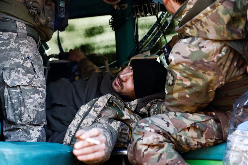 A wounded Ukrainian soldier is treated in a front-line stabilisation ambulance, near Kreminna. Reuters