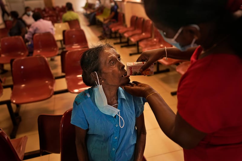 Mudiyansege Chandrawathi, a cancer patient, has a drink after attending a clinic at the national cancer hospital in Maharagama, a suburb of Colombo. AP Photo