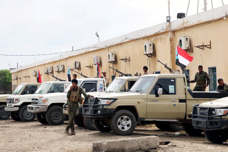 FILE PHOTO: Security forces loyal to the separatist Southern Transitional Council stand next to vehicles as they are deployed in the southern port city of Aden, Yemen December 20, 2020. REUTERS/Fawaz Salman/File Photo