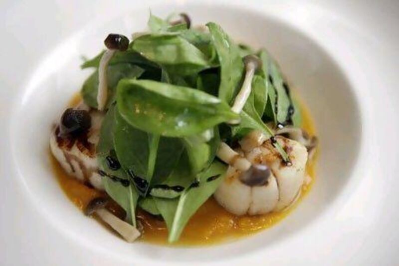 Grilled scallops, roasted squash puree, poplar mushrooms, baby spinach salad, prepared by Marco Pierre White.