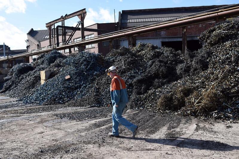 A worker walks past metal shavings in the scrap yard of Sheffield Forgemasters. Oli Scarff / AFP