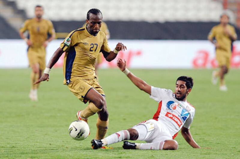 Dubai’s Aboubaca Camara, left, evades an Al Jazira defender during last night’s 2-0 win.