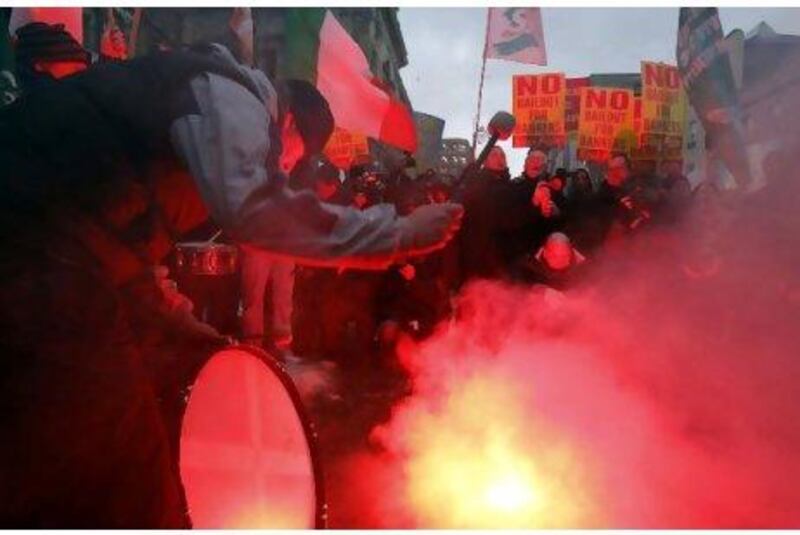 Demonstrators protest outside government buildings as the budget is announced in Dublin yesterday.