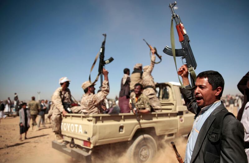 FILE - In this Jan. 3, 2017, file photo, a tribesman loyal to Yemen's Shiite Houthi rebels, right, chants slogans during a gathering aimed at mobilizing more fighters into battlefronts to fight pro-government forces in several Yemeni cities, in Sanaa, Yemen. A false claim by Yemen's Houthi rebels of an attack on Dubai International Airport, the world's busiest airport for international travel, this week may have been quickly disproven by authorities in Dubai, but it shows the looming threats in the region. (AP Photo/Hani Mohammed, File)