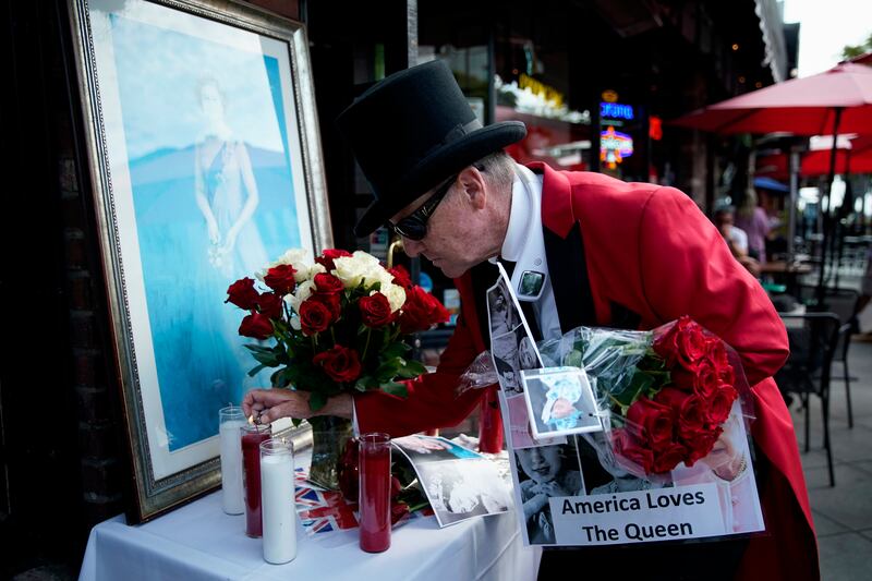 Gregg Donovan lights a candle at a memorial at Ye Olde King's Head British restaurant in Santa Monica, California. EPA