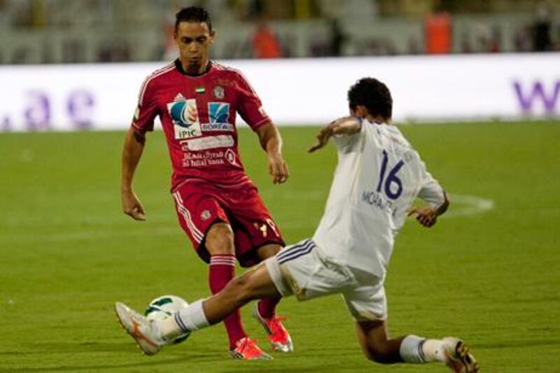 Al Jazira star man Ricardo Oliveira is challenged by Mohamed Abdulrahman during the Super Cup final against Al Ain