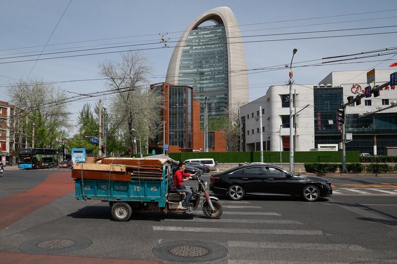 A handful of vehicles hit the road in Beijing as the city authorities tightened Covid controls. EPA