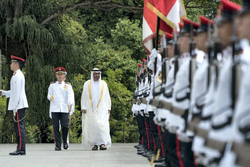 SINGAPORE, SINGAPORE - February 28, 2019: HH Sheikh Mohamed bin Zayed Al Nahyan, Crown Prince of Abu Dhabi and Deputy Supreme Commander of the UAE Armed Forces (C) inspects honor guard during a reception hosted by HE Halimah Yacob, President of Singapore (not shown), at the Istana presidential palace.

( Eissa Al Hammadi for the Ministry of Presidential Affairs )
---