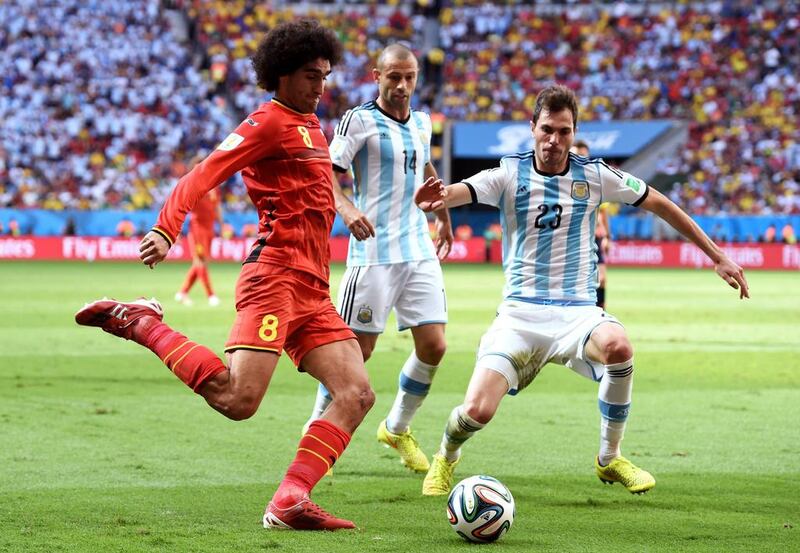Marouane Fellaini of Belgium controls the ball against Jose Maria Basanta of Argentina during their match on Saturday at the 2014 World Cup in Brasilia, Brazil. Matthias Hangst / Getty Images