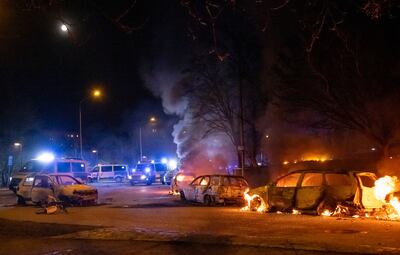 Cars are engulfed by flames after riots broke out at Rosengard in Malmo, Sweden, following rallies led by Danish far-right politician Rasmus Paludan. TT via AP