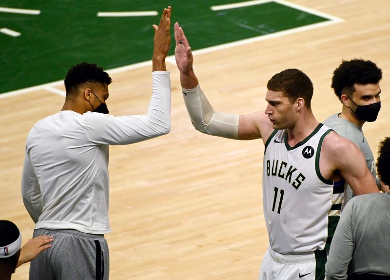 Injured Milwaukee Bucks forward Giannis Antetokounmpo, left, congratulates Brook Lopez after their win over Atlanta Hawks in Game 5 of the NBA Eastern Conference final at the Fiserv Forum on Thursday, July 1. EPA