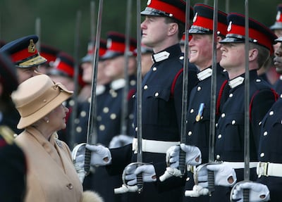 Prince Harry smiling as his grandmother Queen Elizabeth II inspects him and other officers during The Sovereign's Parade at the Royal Military Academy at Sandhurst. PA