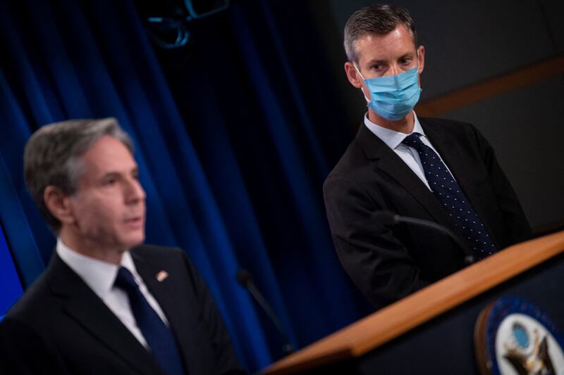 State Department spokesperson Ned Price stands on the side of US Secretary of State Antony Blinken. AFP