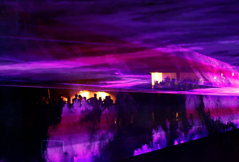 The audience are seen through laser lights during a concert for French composer and music producer Jean-Michel Jarre, in downtown Beirut, Lebanon, on Saturday Sept 18, 2010. (AP Photo/Hussein Malla)