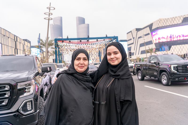 Software engineer Maroua Saoud poses with her mother, who is fond of cars, at the parade at Lusail Boulevard