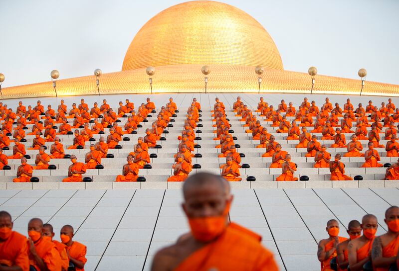 Thai Buddhist monks chant during the mass morning alms-giving ceremony to mark the start of the new year at Wat Phra Dhammakaya Temple in Pathum Thani province, Thailand, 01 January 2024.  Thousands of devotees gathered in a morning almsgiving ceremony to offer foods and essentials to more than 3,000 Buddhist monks to mark the start of 2024 new year, the year of the dragon.   EPA / RUNGROJ YONGRIT