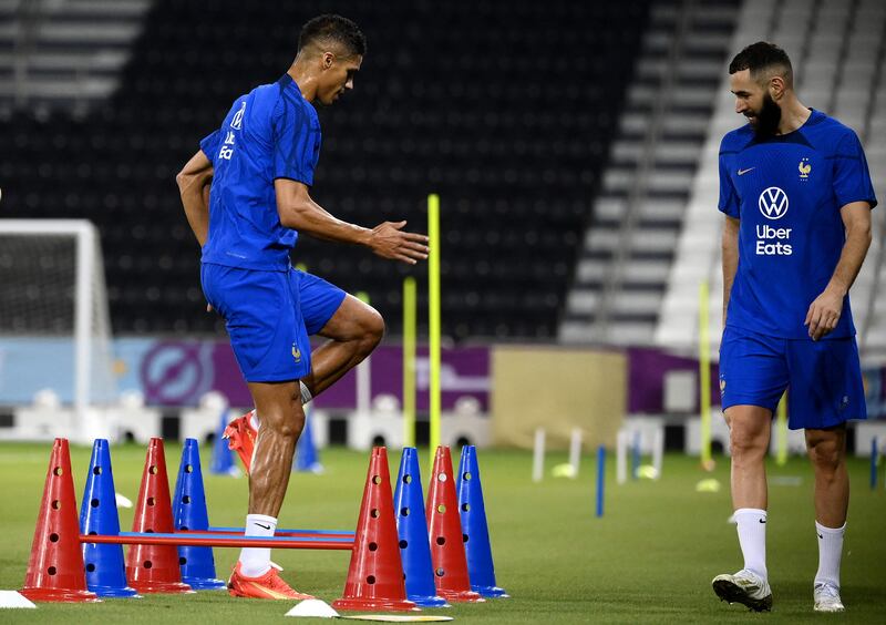 France's Karim Benzema watches Raphael Varane. AFP