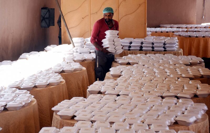 A Pakistan Red Crescent Society worker sorts food parcels to be distributed to people affected by floods in Larkana. EPA