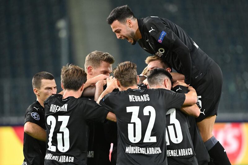 Moenchengladbach's French forward Marcus Thuram celebrates with teammates after the opening goal. AFP