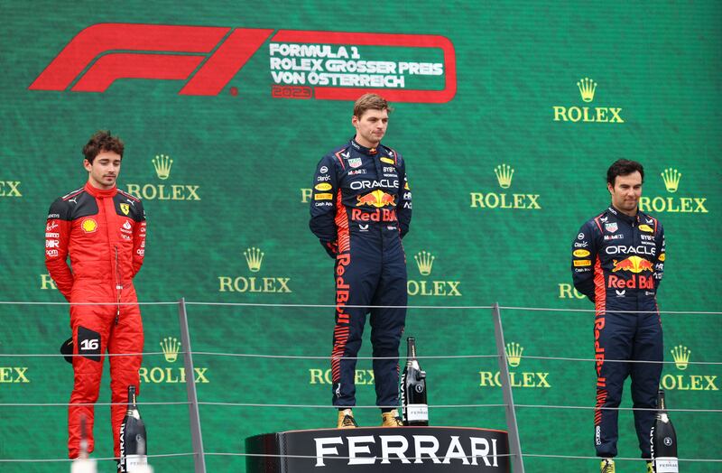 Race winner Max Verstappen, centre, with second place Charles Leclerc, left, and third placed Sergio Perez on the podium. Reuters