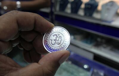DUBAI , UNITED ARAB EMIRATES Ð Nov 11 : One of the customer buying silver coin on Dhanteras at one of the jewelry shop in Meena Bazar in Bur Dubai. Dhanteras is the first day of five days Diwali festival as celebrated in parts of North India. ( Pawan Singh / The National ) For News. Story by Preeti